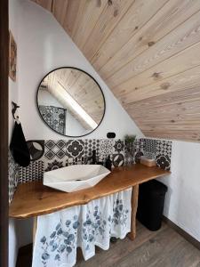 a bathroom with a sink and a mirror at Bieszczadzki Hoży Ryś Apartamenty in Berezka