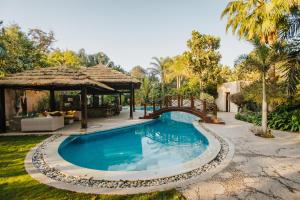 a swimming pool in a yard with a gazebo at Villas D'Egypte Boutique Stay Cairo in Giza