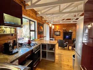 a kitchen with wooden walls and a counter top at Moonriver Cottage, Prime Lagoon Views & Solar Power in Knysna