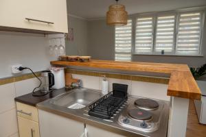 a kitchen with a sink and a stove top oven at Apartament Maya Świnoujście Centrum in Świnoujście