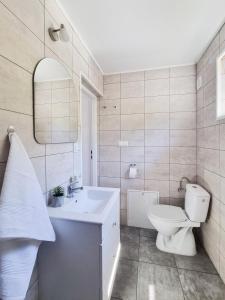 a white bathroom with a toilet and a sink at VIEW of SMEREK- domki z klimatyzacją in Smerek