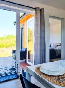 a room with a view of a bed and a table and chairs at VIEW of SMEREK- domki z klimatyzacją in Smerek