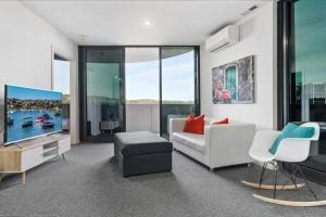 a living room with a couch and a tv at Brilliant 2BR Apartment in Belconnen in Belconnen