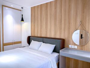 a bedroom with a white bed and a mirror at Happy Villa Hạ Long in Ha Long +18 photos