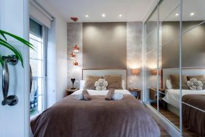 a bedroom with a large bed with towels on it at Cinco balcones a la Catedral by Unique Rooms in Burgos