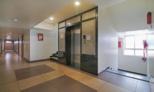 a hallway with a glass door in a building at Itsy By Treebo - N Square in Vijayawāda