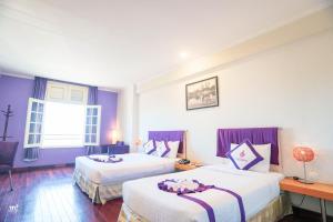 Postel nebo postele na pokoji v ubytování TTC Hotel - Ngoc Lan