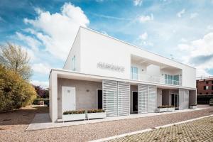 a white building with a sign on it at Residence Peloni in Arezzo