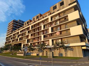 a tall building on the side of a street at Cozy one-room apartment with garage and AC in Bratislava