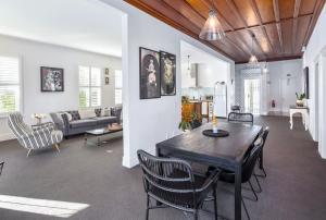 a dining room and living room with a table and chairs at Altitude Apartment, Martinborough in Martinborough 