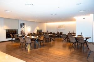 a restaurant with tables and chairs in a room at Jasmine Garden Hotel in Jeddah