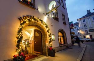 an entrance to a building with christmas lights at Hotel Wolf in Salzburg