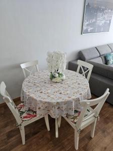 a dining room table with a flower arrangement on it at Belle maison ! in Brussels +9 photos