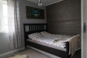 a bedroom with a bed with a brick wall at Luxury Norwegian Cottage in Hurdal