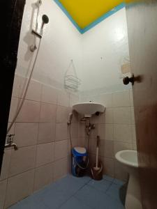 a bathroom with a sink and a toilet at Yuki Lodge - El Nido PH in El Nido