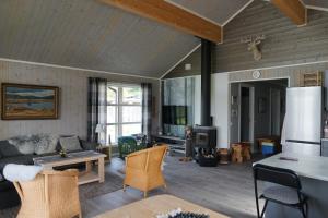 a living room with a couch and a table at Luxury Norwegian Cottage in Hurdal