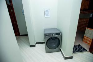 a washer and dryer in a corner of a room at Niwa Apartments in Dar es Salaam