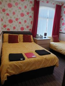 ein Schlafzimmer mit einem Bett mit zwei Laptops darauf in der Unterkunft Bianca Guesthouse in Blackpool