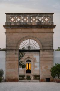 an entrance to a building with an archway at Masseria Gorgognolo in Ostuni