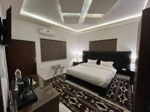a bedroom with a bed and a television in it at Mansi Residence in Wadi Musa