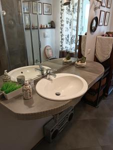 a bathroom with a sink and a large mirror at Angels Home in Livorno