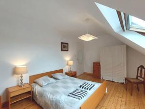 a bedroom with a large bed and a staircase at Maison familiale bord de mer in Douarnenez