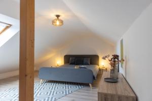 a bedroom with a blue bed and a wooden table at LM3-32 - Ferienwohnung Typ AB Komfort in Schottwarden