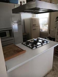 a kitchen with a stove top oven next to a refrigerator at Angels Home in Livorno