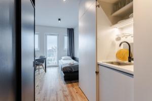 Pokój z umywalką i łóżkiem w pokoju w obiekcie Apartament Monika w Poznaniu