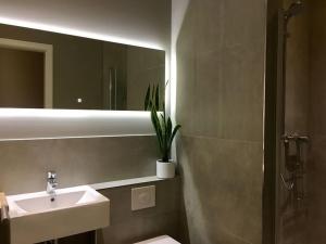 a bathroom with a sink and a toilet and a mirror at Berlin Style Apartments in Berlin