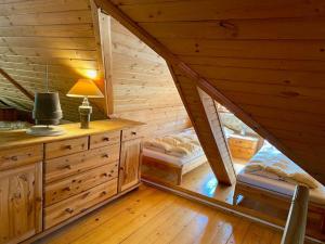 a bedroom in a wooden cabin with a attic at Chalet Gaïa in Międzybrodzie Żywieckie