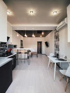 uma cozinha e sala de jantar com mesas e cadeiras em 2-к студія у Центрі біля Стадіону та Корпусного саду - Мережа HELEN em Poltava