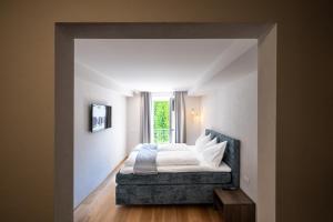 a bedroom with a bed and a window at Odilia - Historic City Apartments - center of Brixen, WLAN and Brixencard included in Bressanone
