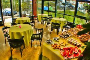 a restaurant with tables and chairs with food on them at Hotel Stellamaris in Combarro