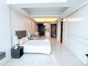 a bedroom with a bed and a living room at Damas Residence Kuala Lumpur in Kuala Lumpur