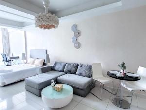 a living room with a couch and a table at Damas Residence Kuala Lumpur in Kuala Lumpur