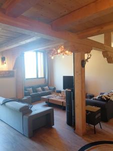 a living room with couches and a couch and a table at Chalet Kelly in Les Orres