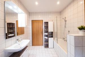 a white bathroom with a sink and a shower at Ferienwohnung Annemarie in Mieders