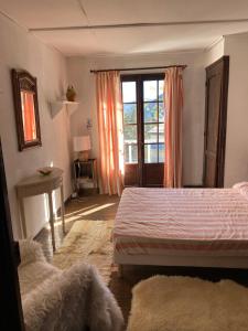 a bedroom with a bed and a window at Auron Chalet Casanova centre et pistes à pied in Auron