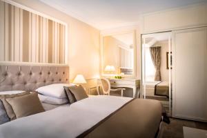 Rúm í herbergi á Hotel Kvarner - Liburnia