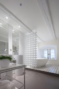 a bathroom with a sink and a large mirror at Domaine du Kaegy - Hébergements 5 étoiles in Steinbrunn-le-Bas
