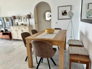 a dining room with a wooden table and chairs at Pepe Beach Vista al Mar Apartment Estepona in Estepona +45 photos