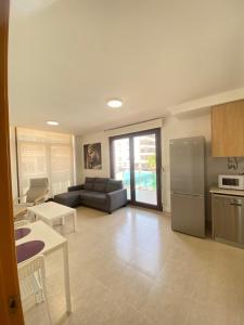 a large living room with a couch and a refrigerator at Mirador dels Terrers in Benicàssim