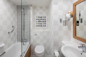 a bathroom with a toilet and a sink and a shower at Holiday Inn London - Gatwick Airport, an IHG Hotel in Horley