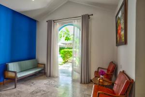a living room with a couch and a sliding glass door at Salmalia Boutique Hotel & Spa in Danang