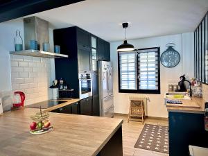 a kitchen with blue cabinets and a wooden counter top at Family Oasis with 3 bedrooms near Paris in Chennevières-sur-Marne