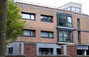 a red brick building with black windows at Stay & Work - 6 single beds - central in Emmerich