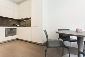 a dining room with a table and chairs at Soho Luxury 1 Bedroom Apartment by Concept Apartments in London