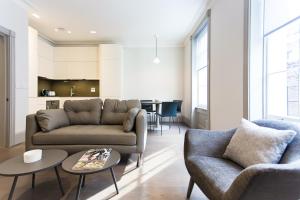 a living room with a couch and a table at Soho Luxury 1 Bedroom Apartment by Concept Apartments in London