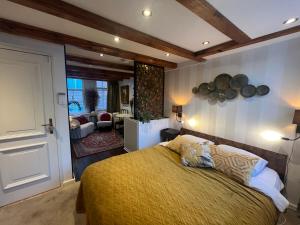 a bedroom with a bed and a living room at The Enlightened House Luxury Suites in Amsterdam